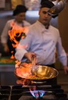 Chef doing flambe on food photo