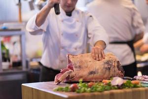 chef cutting big piece of beef photo