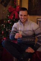 Happy young man with a glass of champagne photo