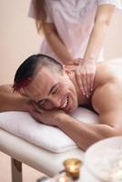 young man having a back massage photo
