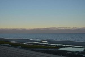 Stunning beach on the coast of cape cod during a sunset photo