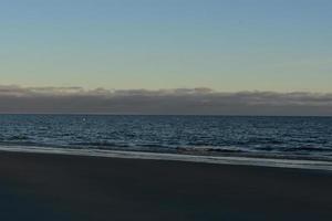 Cloudy afternoon on the coast of cape cod with dark waters photo