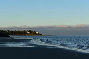 Beautiful coast of cape cod with small waves crashing in photo