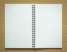 blank spiral notepad on wood background photo