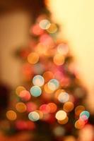 Christmas lights on xmas tree defocused. Holiday bokeh background photo