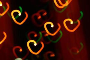 abstract heart bokeh orange lights on dark background photo