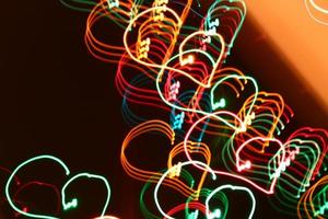 blurred abstract christmas lights lines on black background photo