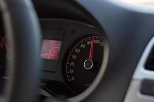 high speed on tachometer on black dashboard in automobile photo