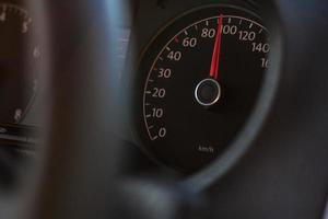 high speed on speedometer in automobile on dark background photo