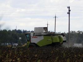 KYIV OBLAST, UKRAINE - OCTOBER 02, 2022 Combine harvester mows and harvests photo