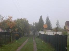 Autumn morning mist in the village photo