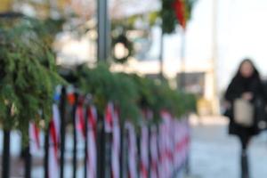 blurry background of candycane lights and garland up with woman holiday shoppping photo