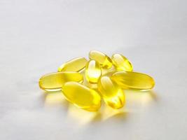 Closed capsules with dietary supplement. Fish oil, omega 3, vitamin A, vitamin D, vitamin E. Selective focus photo