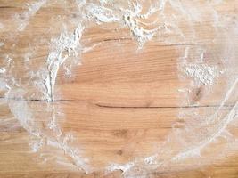 White flour on wooden table. Free space for text. Top view photo