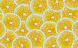 Lemon slices background. Cut yellow citrus fruit. photo