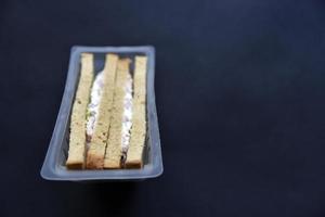 Delicious sandwiches in plastic packaging close-up on a black background. Delicious breakfast in a package. photo