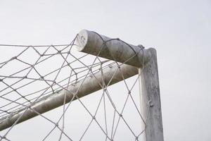 right corner of the soccer goal net with a white sky background photo