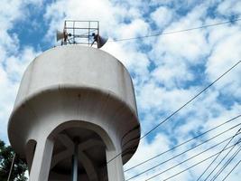 White water tank On the background is an empty blue sky.Minimal concept. photo