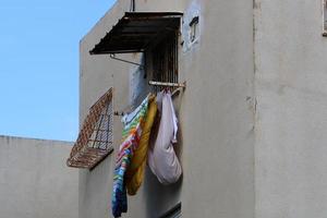 Washed clothes and linen dries on the balcony. photo