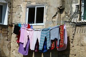 Washed clothes and linen dries on the balcony. photo