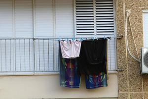 Washed clothes and linen dries on the balcony. photo