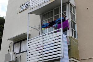 Washed clothes and linen dries on the balcony. photo