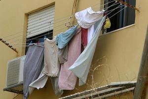 Washed clothes and linen dries on the balcony. photo