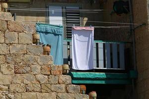 Washed clothes and linen dries on the balcony. photo