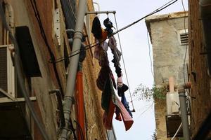 Washed clothes and linen dries on the balcony. photo