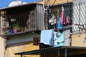 Washed clothes and linen dries on the balcony. photo