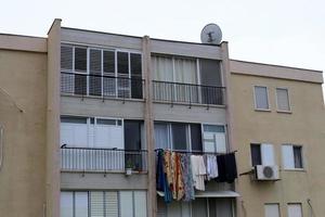 Washed clothes and linen dries on the balcony. photo