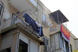Washed clothes and linen dries on the balcony. photo