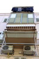 Washed clothes and linen dries on the balcony. photo