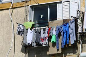 Washed clothes and linen dries on the balcony. photo