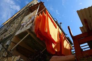 Washed clothes and linen dries on the balcony. photo