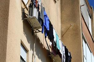 Washed clothes and linen dries on the balcony. photo