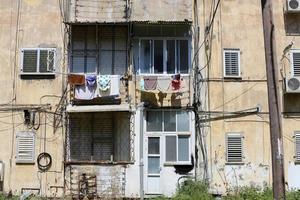 Washed clothes and linen dries on the balcony. photo