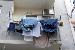 Washed clothes and linen dries on the balcony. photo