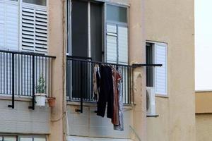 Washed clothes and linen dries on the balcony. photo