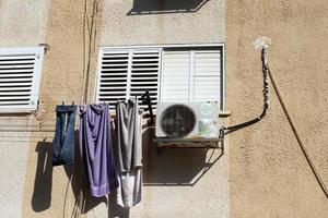 Washed clothes and linen dries on the balcony. photo