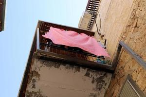 Washed clothes and linen dries on the balcony. photo