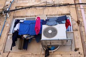 Washed clothes and linen dries on the balcony. photo