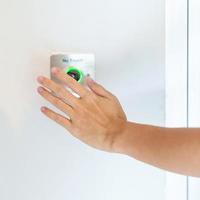 Hand open the door by No touch sensor switch on the wall at office or apartment. Contactless, modern, Technology and safety concept photo