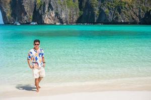 happy tourist man at Maya Bay beach on Phi Phi island, Krabi, Thailand. landmark, destination Southeast Asia Travel, vacation and holiday concept photo