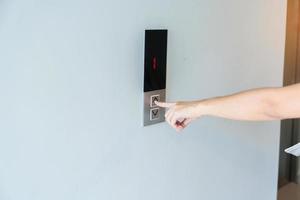 Hand finger press the Elevator button, woman waiting for Elevator in office or apartment photo