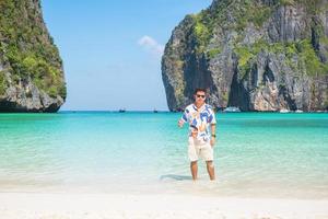 happy tourist man at Maya Bay beach on Phi Phi island, Krabi, Thailand. landmark, destination Southeast Asia Travel, vacation and holiday concept photo