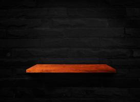 Wooden shelves on black brick wall texture background with clipping path for design photo