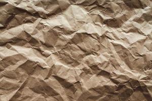 Crumpled paper texture, brown recycled paper abstract background photo