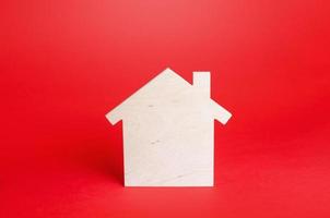 Empty blank wooden house on red background. Buying and selling real estate. Housing, realtor services. Renovation and home improvement. Short and long term rentals. Mortgage loan. Building maintenance