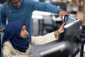 young black muslim female software developer at work photo